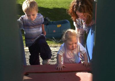 
Two-year old Samuel Jennings, left, and Mataiah Achziger, 21/2, with the help of registered nurse Kathryn Bader, play on the slide at the Spokane Child Development Center. Samuel is in the child-care program at the center and Mataiah is in Children FIRST, an early-intervention program.
 (Liz Kishimoto / The Spokesman-Review)