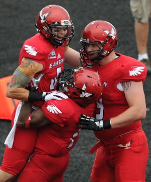 Eastern Washington receiver Cory Mitchell celebrates with teammates after catching a touchdown pass against Western Oregon during the first half of a college football game on Saturday, September 7, 2013, on Roos Field in Cheney, Wash. (Tyler Tjomsland / The Spokesman-Review)