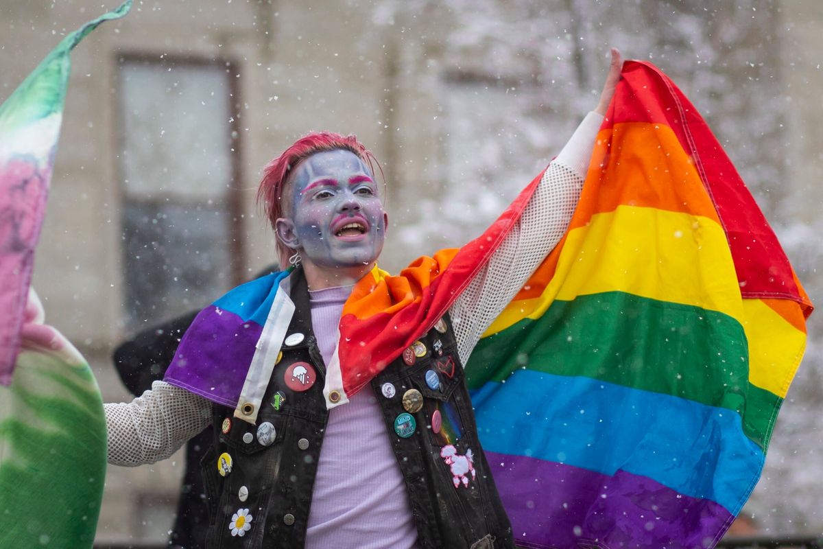 Rex Pistols performs with a rainbow flag during a drag show and protest in front of the Montana State Capitol in Helena on Thursday.  (Mike Clark/For the Daily Montanan)