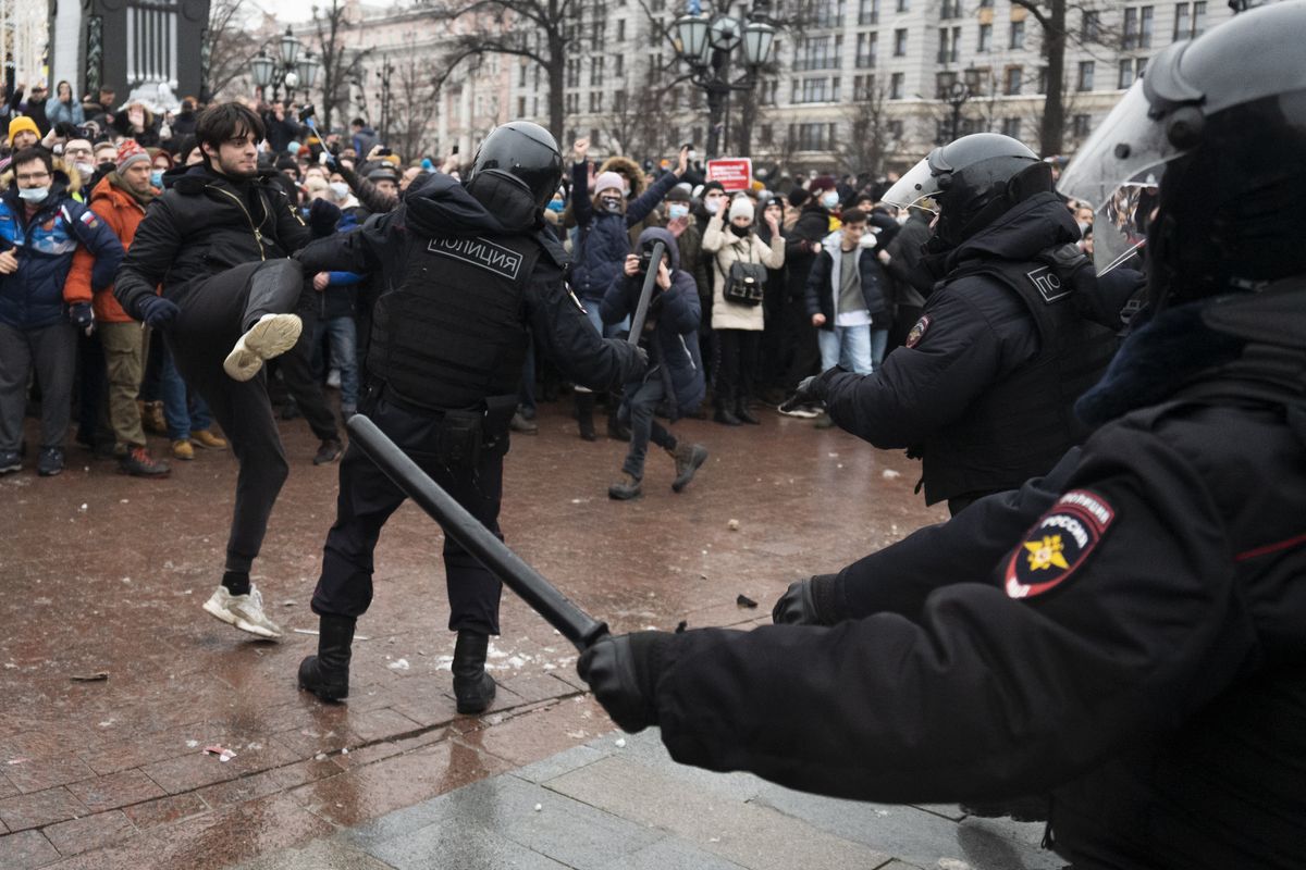 A demonstrator clashes with a police officer during a protest against the jailing of opposition leader Alexei Navalny in Pushkin square in Moscow, Russia, Saturday, Jan. 23, 2021. Russian police arrested more than 3,400 people Saturday in nationwide protests demanding the release of opposition leader Alexei Navalny, the Kremlin