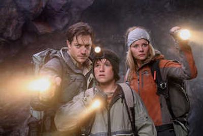 In this photo released by New Line Cinema, actors from left, Brendan Fraser, Josh Hutcherson and Anita Briem are shown in a scene from 