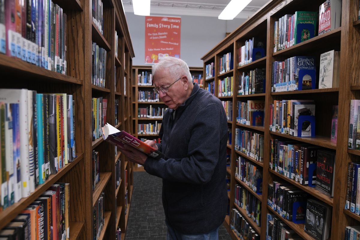 David Hemphill browses for books Wednesday in the Dayton Memorial Library shelves. He said he checks out two or three books a week.  (James Hanlon/The Spokesman-Revview)