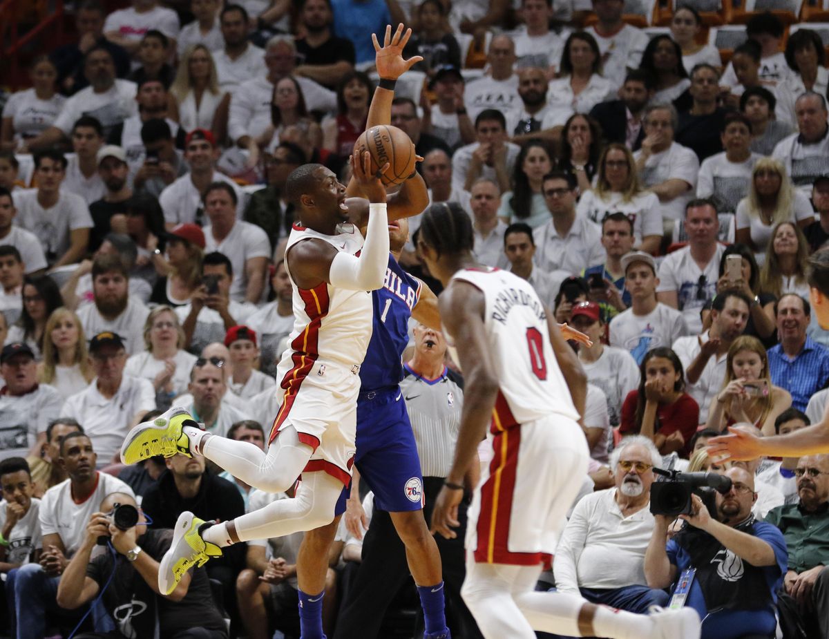 Miami Heat guard Dwyane Wade, left, shoots as Philadelphia 76ers guard Justin Anderson (obscured) defends in the second quarter in Game 4 of a first-round NBA basketball playoff series, Saturday, April 21, 2018, in Miami. (Joe Skipper / Associated Press)