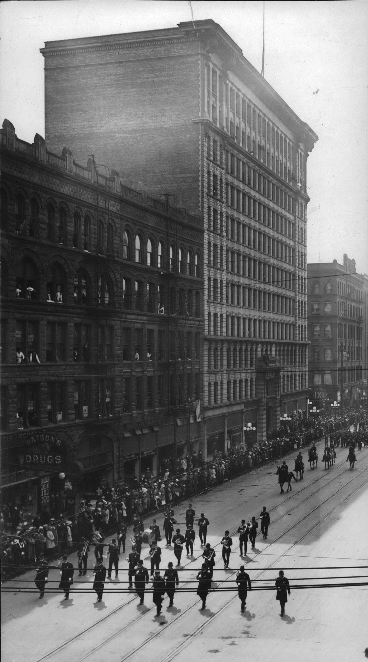 1928 - An unidentified parade passes the Granite Block, left, and the Paulsen Building, center, on the 400 block of West Riverside Ave. in 1928. Both buildings represented Spokane’s boom era from 1890 to 1915. (Frank Palmer / SR)
