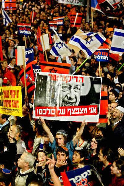 
Israelis demonstrate in front of the national parliament building in Jerusalem on Sunday to protest Prime Minister Ariel Sharon's plan to evacuate all 21 Jewish settlements from the Gaza Strip and four from the West Bank.
 (Associated Press / The Spokesman-Review)