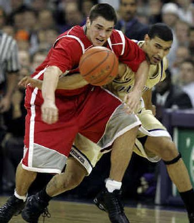 
Sacred Heart University's Drew Shubik, left, fights for the ball with Washington's Tre Simmons in the first half.
 (Associated Press / The Spokesman-Review)
