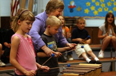 
Skyview Elementary music teacher Linda Wruble helps Matt Ballensky, 8, get the beat for the song 