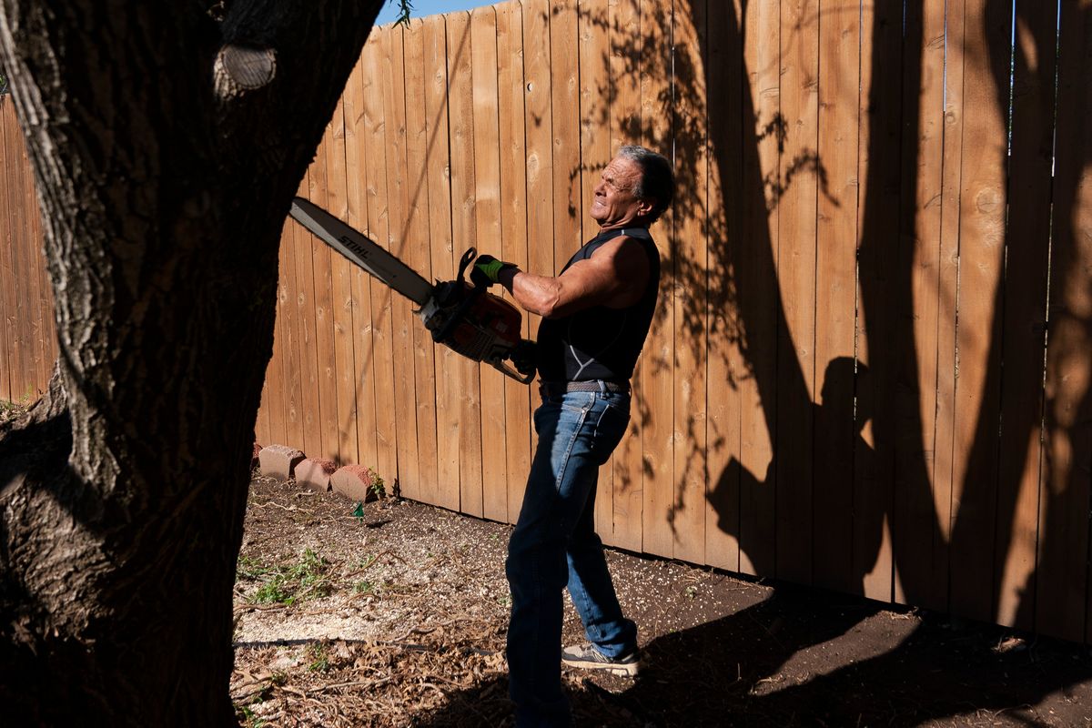 Jerry Dean McLain cuts down a tree in Oklahoma City on April 11. MUST CREDIT: Nick Oxford for The Washington Post  (Nick Oxford/For The Washington Post)