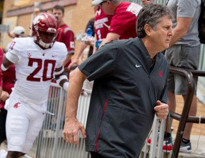 Washington State Cougars head coach Mike Leach heads to the field against Wyoming during the first half of a college football game on Saturday, September 1, 2018, at War Memorial Stadium in Laramie, Wyo. (Tyler Tjomsland / The Spokesman-Review)