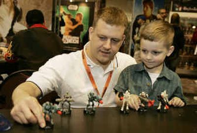 
Scott Sparrow and his son, Ethan, of Somers, Conn., play with Star Wars figurines during 