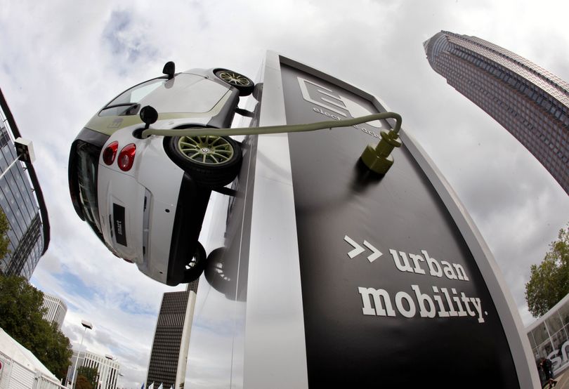 A Smart electro drive car hangs from a column on the Frankfurt fairground Monday, a day before the International Car Fair IAA opens first to the media and two days later for the public.  (Associated Press / The Spokesman-Review)