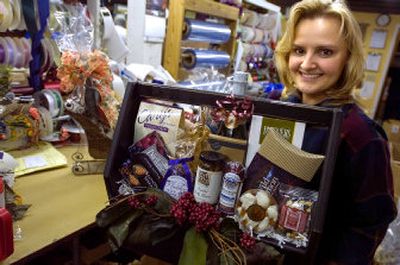 
Sharon Strine of Simply Northwest holds a gift basket she's just finished. The company makes themed baskets for retail and corporate customers. 
 (Christopher Anderson photos/ / The Spokesman-Review)