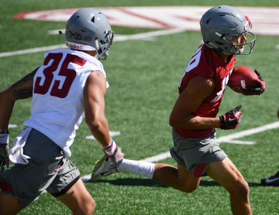 WSU's Rodrick Fisher (88) runs the ball past Armani Marsh (35) during practice on Friday, August 3, 2018, at Martin Stadium in Pullman, Wash. (Tyler Tjomsland / The Spokesman-Review)