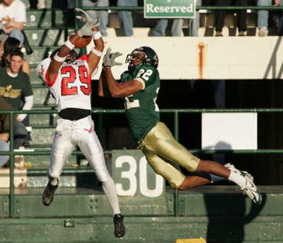 
Eastern Washington University defensive back Jesse Hendrix, left, breaks up a pass intended for Cal Poly receiver Jason Holmes on Saturday. 
 (Nick Hoover/Special to / The Spokesman-Review)