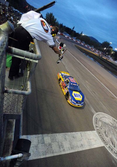 Eric Holmes takes the checkered flag. (Photo courtesy of Steve Dykes/Getty Images) (Steve Dykes / Getty Images North America)