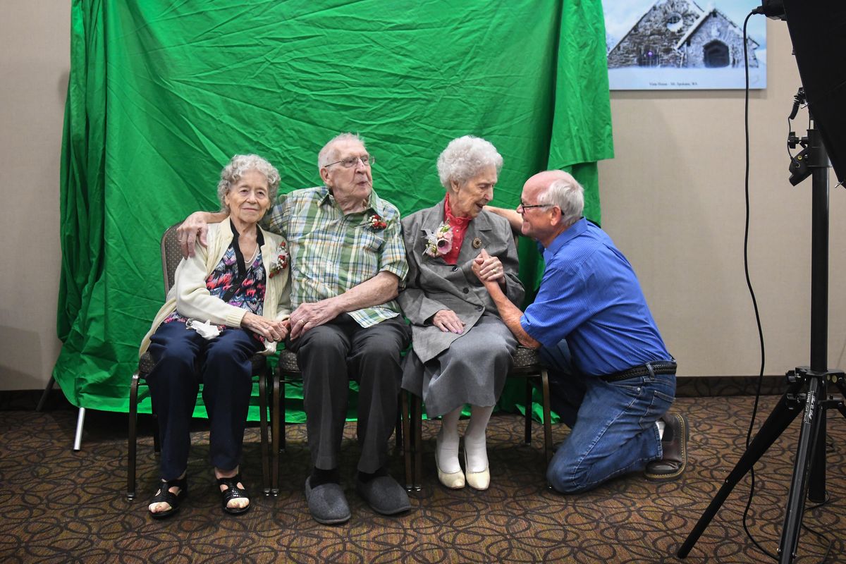 Mountain View Assembly of God Pastor Dan Henshaw, right, visits with 108-year-old Hazel Young, of Des Moines, Iowa during her birthday party, Tuesday, June 12, 2108, at the Quality Inn Oakwood in Spokane, Wash. For her birthday wish, she wanted to visit her brother, George Davis, center and his wife Mary, at left. The trio gathered to have their picture taken by a relative from Idaho. Henshaw is the Davis’ pastor. (Dan Pelle / The Spokesman-Review)