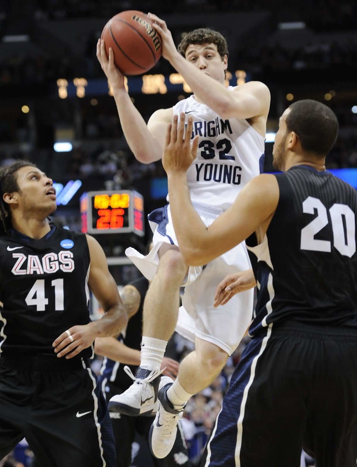 BYU guard Jimmer Fredette (32) goes up for a shot against Gonzaga guard Steven Gray (41) and Gonzaga forward Elias Harris (20) in the first half of a Southeast regional third round NCAA tournament college basketball game, Saturday, March 19, 2011, in Denver. (Jack Dempsey / Associated Press)