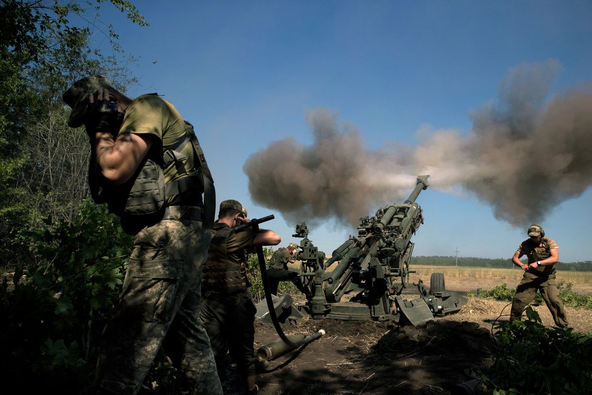 Ukrainian soldiers fire a U.S.-supplied M777 howitzer at a Russian position, in the Donetsk region of Ukraine on June 21. Heavy use of artillery and tanks is chewing up modest stockpiles of artillery, ammunition and air defenses.  (TYLER HICKS)