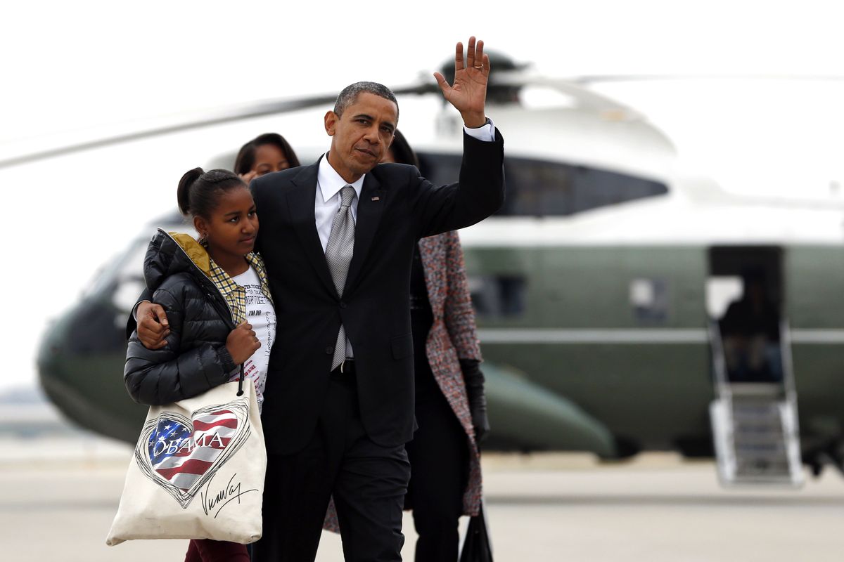 President Barack Obama, first lady Michelle Obama and their daughters Sasha, front left, and Malia, walk from Marine One to board Air Force One at Chicago O