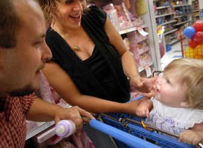 
Rhylee Murrin, who turns a year old on Tuesday, responds to her parents, Rocco and Jaimasa Murrin, while they shop for her birthday present  Friday afternoon. 
 (Holly Pickett / The Spokesman-Review)