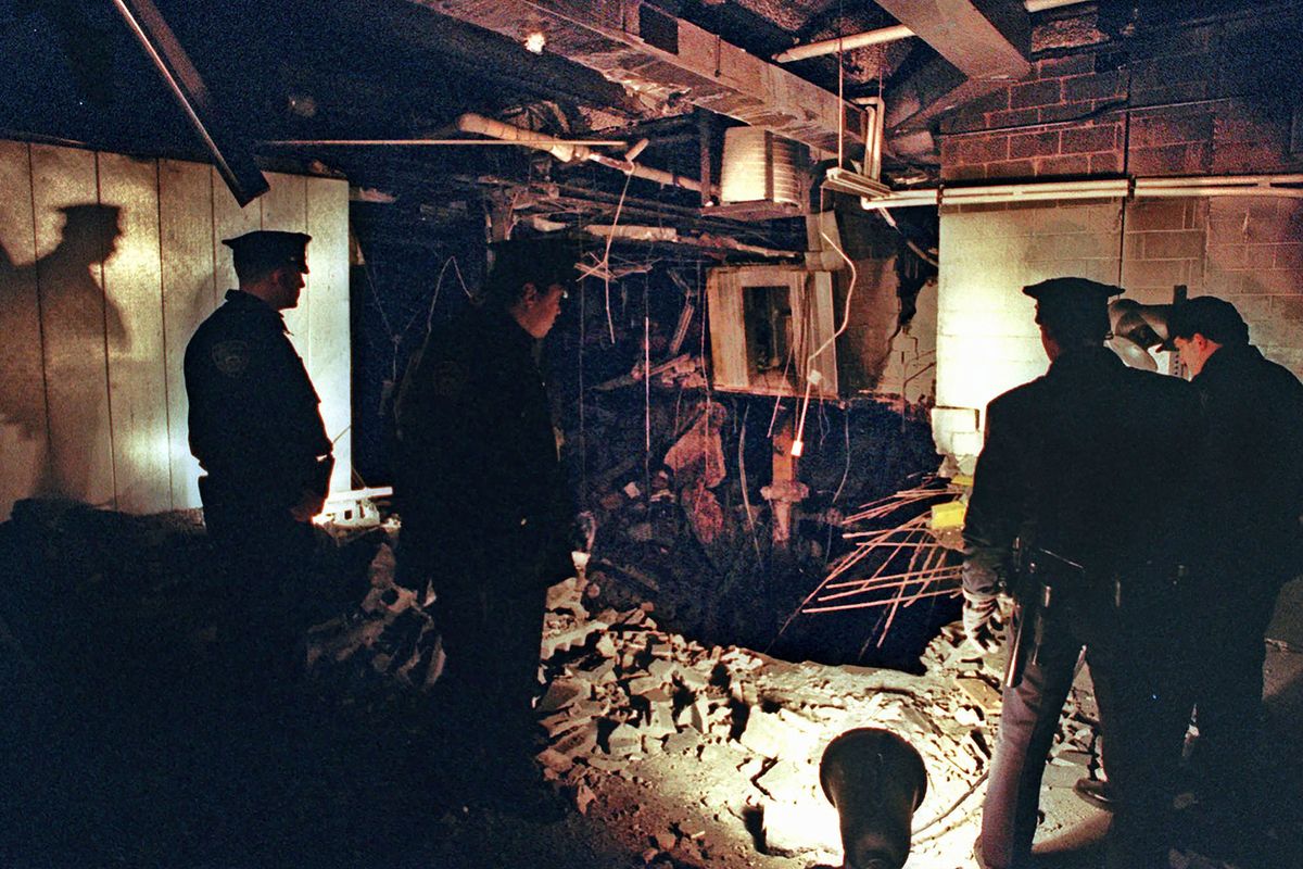 FILE - In this Feb. 27, 1993, file photo, Port Authority and New York City Police officers view the damage caused by a truck bomb that exploded in the garage of New York
