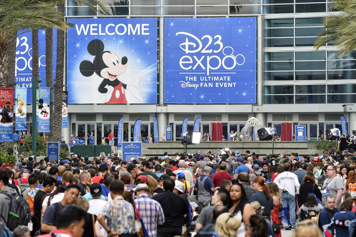 A crowd of people wait to enter the D23 Expo as crews do interviews outside the Anaheim Convention Center in Anaheim, Calif., on July 14, 2017. (Jeff Gritchen / AP)
