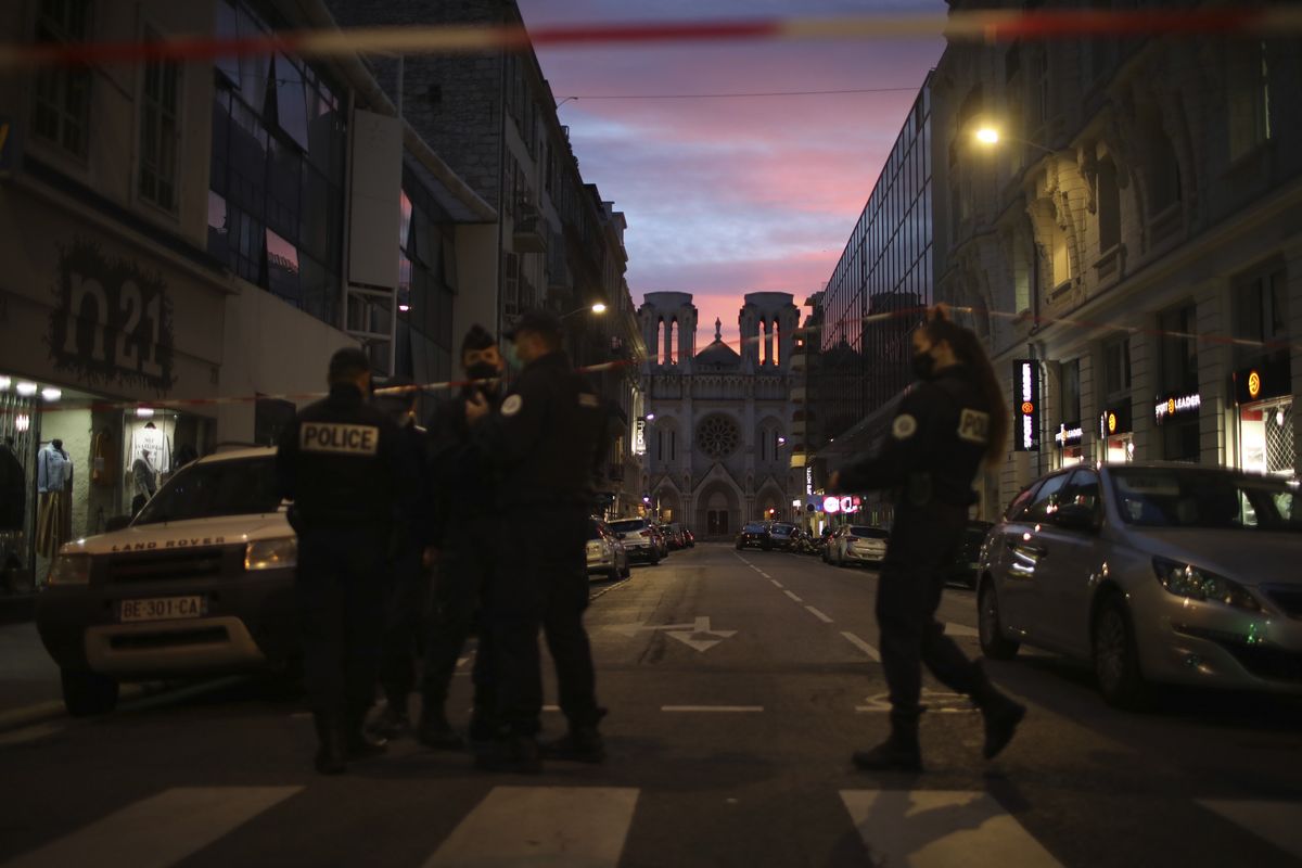 Police work behind a restricted zone near the Notre Dame church in Nice, southern France, after a knife attack took place on Thursday, Oct. 29, 2020. An attacker armed with a knife killed at least three people at a church in the Mediterranean city of Nice, prompting the prime minister to announce that France was raising its security alert status to the highest level.  (Daniel Cole)