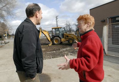 Spokane Valley Partners CEO Ken Briggs and Spokane Valley Partners Food Bank Director Barb Bennett watch as construction crews begin site preparation Monday for the new 4,300-square-foot food warehouse. The food bank will stay open during the work.  (J. Bart Rayniak / The Spokesman-Review)