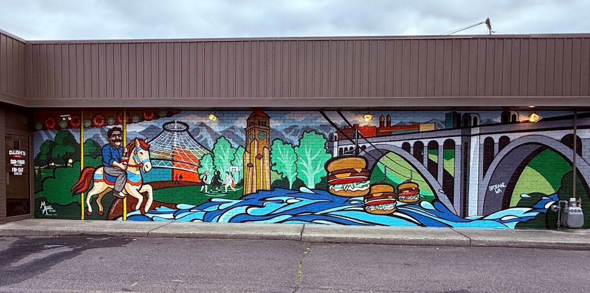 Last summer, Kansas-based artist, Mindy Allen, painted this brilliant mural on an exterior wall at D. Lish’s Burgers in Spokane. Her daughter, Haley, assisted with the project which was part of an inside-out restaurant remodel. Restaurant founder Dave Lish is depicted riding a Riverfront Park Looff Carrousel horse. His right hand holds a drink cup.  (Courtesy of Mindy Allen)