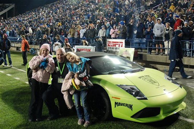 This hand out photo provided on Wednesday Dec. 21, 2011 by Maverik shows David Dopp, 34, of Santaquin, Utah, posing for a photo with his daughters Shayla, left, and Olivia, right, after winning a Lamborghini on Nov.12, 2011 in Maverik's Sweepstakes at Brigham Young University's LaVell Edwards Stadium in Provo, Utah. Dopp crashed the $300,000 sports car six hours after he got it. ( (AP Photo/Maverik, Kyle Buhler))