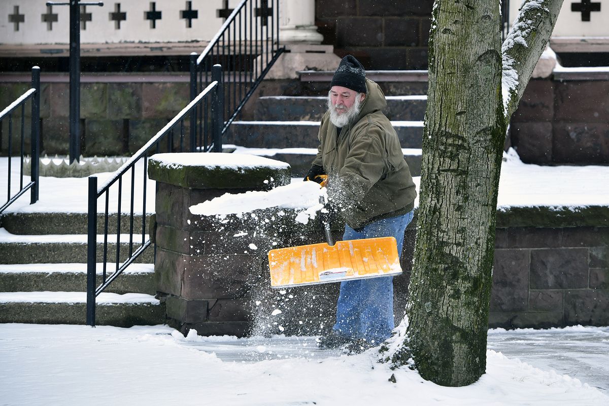 Ron Williams, a volunteer at First United Brethren Church in Johnstown, Pa. shovels snow from the sidewalk outside the church on Monday, Feb. 1, 2021.  (Todd Berkey)