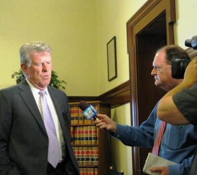 Idaho Gov. Butch Otter answers questions from TV reporter Scott Logan after voting Monday to pay attorney fees to the winning sides in three big lawsuits. (Betsy Russell / Eye on Boise)