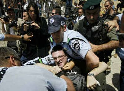 
Israeli police arrest an ultra-Orthodox Israeli protester in front of the Western Wall, Judaism's most holy site, on Sunday. 
 (Associated Press / The Spokesman-Review)