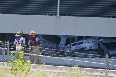 Fire crews view  vehicles in a collapsed garage in Atlanta on Monday.  (Associated Press / The Spokesman-Review)