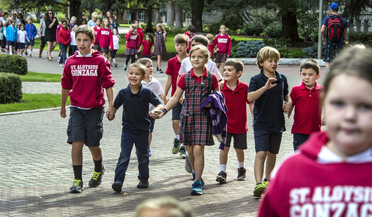 Over 300 students from St. Aloysius Gonzaga Catholic School make their way from the class room to St Aloysius Catholic Church on the Gonzaga University campus on Thursday to celebrate the school turning 100 years old on Sept. 8, 2016. (Dan Pelle / The Spokesman-Review)