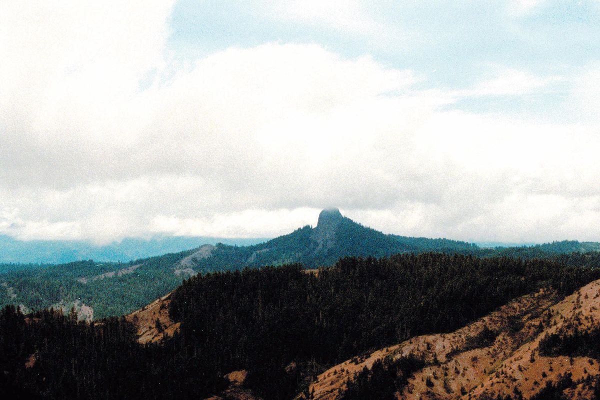 In this July 6, 2000, file photo, Pilot Rock rises into the clouds in the Cascade-Siskiyou National Monument near Lincoln, Ore. U.S. Secretary of Interior Ryan Zinke will be visiting the Cascade-Siskiyou National Monument in Oregon this weekend as part of the review ordered by President Donald Trump of 27 national monuments established by three former presidents. (Jeff Barnard / Associated Press)