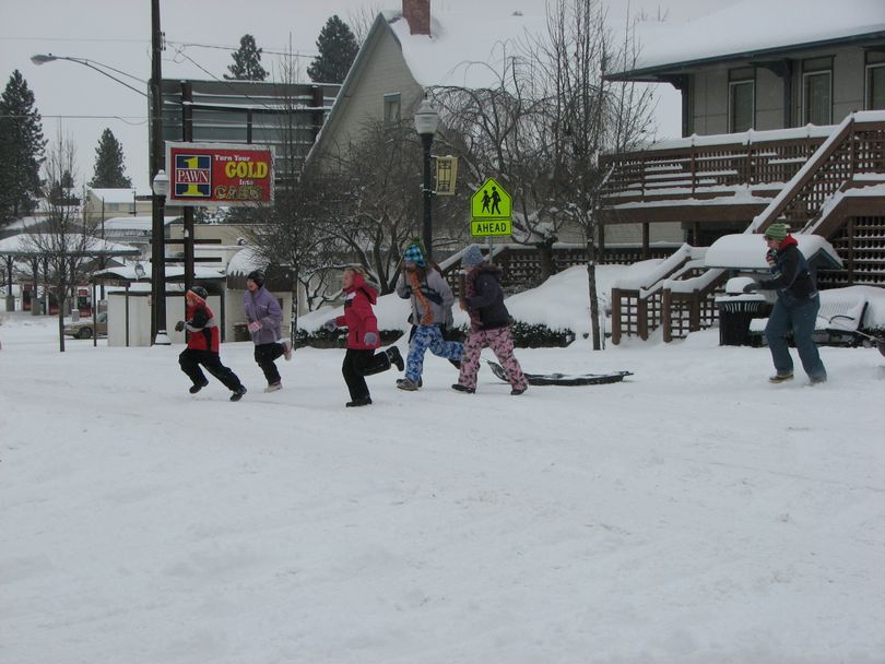 A group of kids cross South Perry Street headed for sledding in Grant Park on Feb. 24, 2011. (Pia Hallenberg)