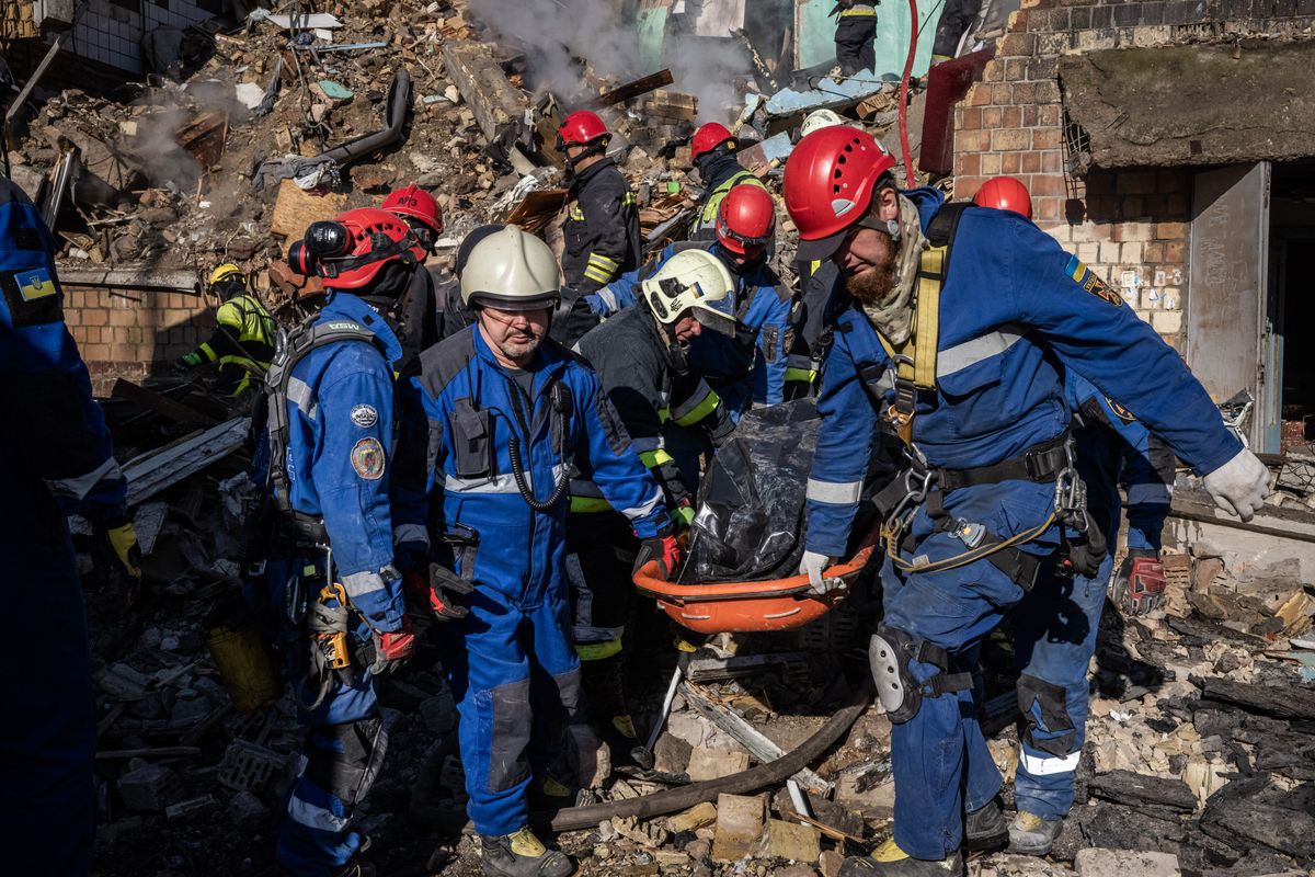 Emergency responders and firefighters remove a body from the site of a Russian strike on an apartment block in eastern Kyiv on Thursday. MUST CREDIT: Ed Ram/For The Washington Post (Ed Ram/For The Washington Post)