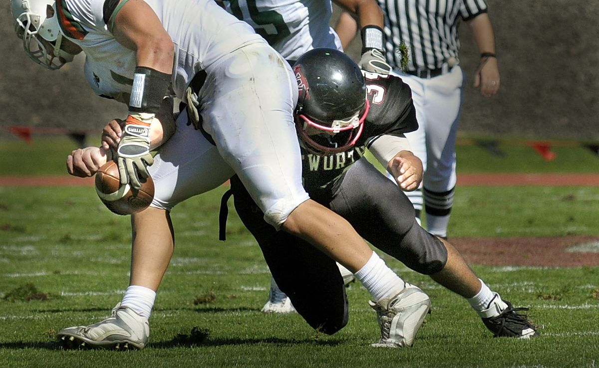 Whitworth’s Nick Ashley knocks the ball loose from La Verne punter Jason Carpenter. The Pirates recovered and later scored. (Christopher Anderson / The Spokesman-Review)