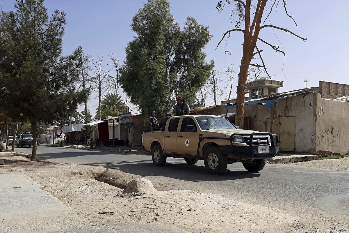 Afghan security personnel patrol a deserted street during fighting between Taliban and Afghan security forces, in Lashkar Gah, Helmand province, southern Afghanistan, Tuesday, Aug. 3, 2021. The Taliban pressed on with their advances in Afghanistan