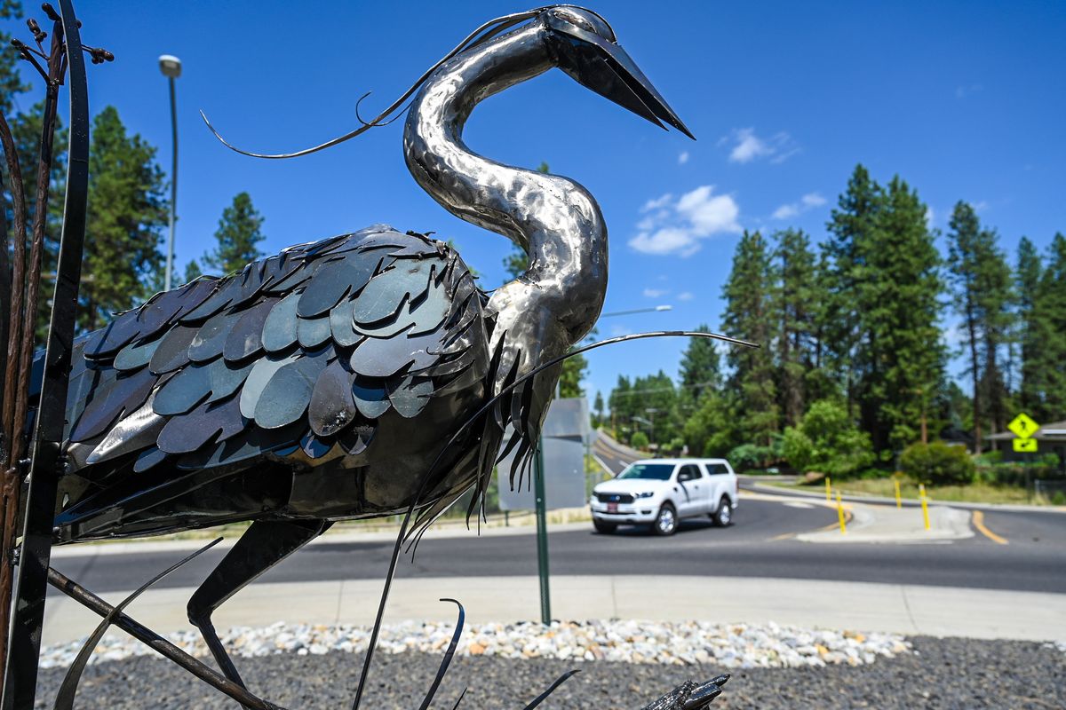 Roundabout traffic rolls past a steel heron art piece installed at the corner of Mill Road and Waikiki Road, Monday, July 17, 2023, in Mead.  (DAN PELLE/THE SPOKESMAN-REVIEW)