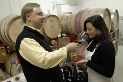 
Tracy Nodland smells the bouquet of a 2006 vintage private blend of wine that she and her husband, Tim, are considering. Self-taught winemakers, they were sampling Monday during their preliminary blending trials of their 2006 vintage. 
 (J. Bart Rayniak / The Spokesman-Review)