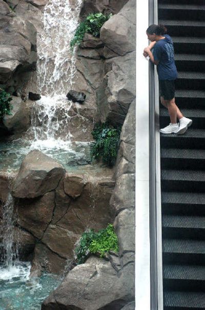 
Jackie Vaughn, 14, rides the escalator in the STA Plaza before catching a bus home from basketball camp on Tuesday afternoon. 
 (Holly Pickett / The Spokesman-Review)