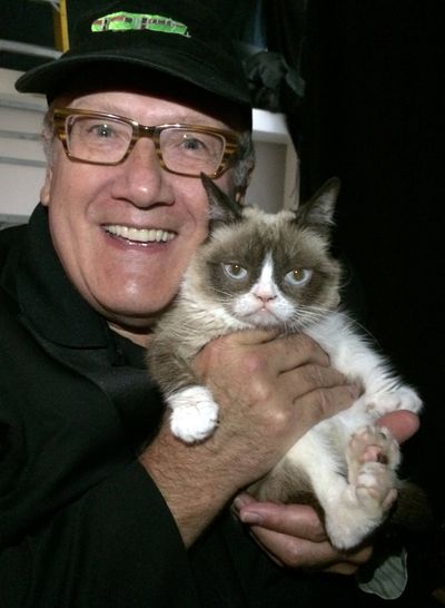 Doug Clark cuddles Grumpy Cat, one of the only celebrities who would let him do such a thing.