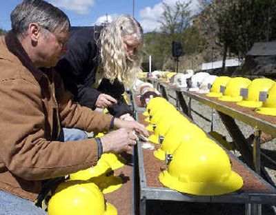 
Brian and Jann Higdem place name tags on hard hats representing Sunshine Mine fire victims. 
 (The Spokesman-Review)
