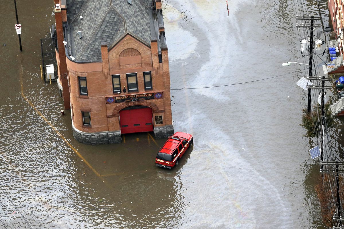 A firehouse is surrounded by floodwaters in the wake of superstorm Sandy on Tuesday, Oct. 30, 2012, in Hoboken, N.J. Sandy, the storm that made landfall Monday, caused multiple fatalities, halted mass transit and cut power to more than 6 million homes and businesses. (Mike Groll / Associated Press)