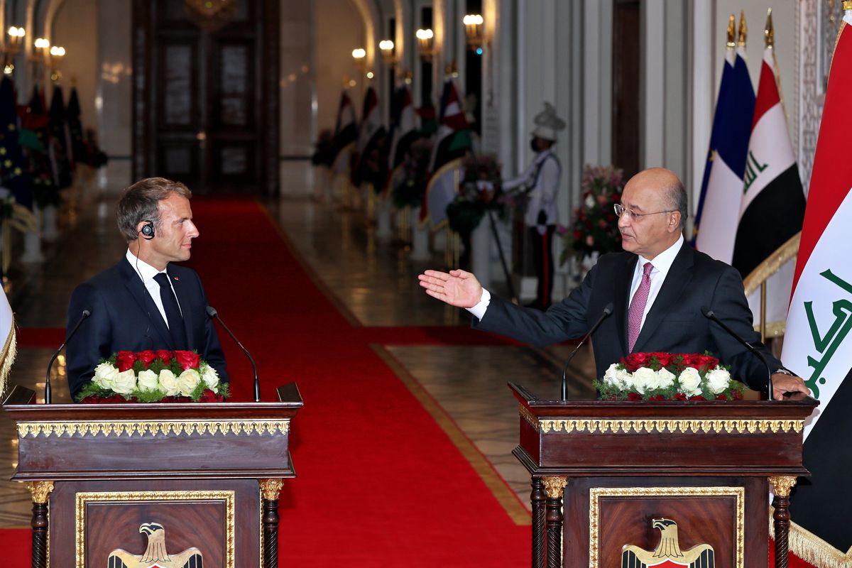 Iraqi President Barham Salih, right, and French President Emmanuel Macron attend a press conference, in Baghdad