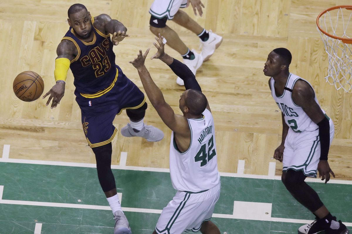 Cleveland Cavaliers forward LeBron James (23) passes the ball as Boston Celtics center Al Horford (42) and guard Terry Rozier, right, defend during the first half of Game 5 of the NBA basketball Eastern Conference finals, on Thursday, May 25, 2017, in Boston. (Charles Krupa / Associated Press)