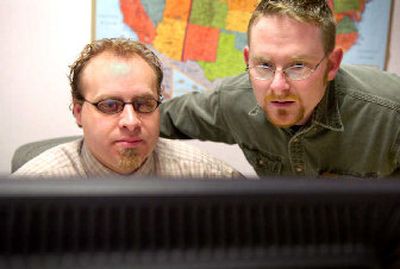 
Michael Pilsch and Jason Hubbard of Geeks on Wheels make sure everything is running smoothly at a Spokane business Tuesday morning. 
 (Holly Pickett / The Spokesman-Review)
