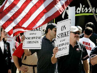 
Some 100 striking Northwest Airlines mechanics and supporters from other unions picket Tuesday in Minneapolis.
 (Associated Press / The Spokesman-Review)